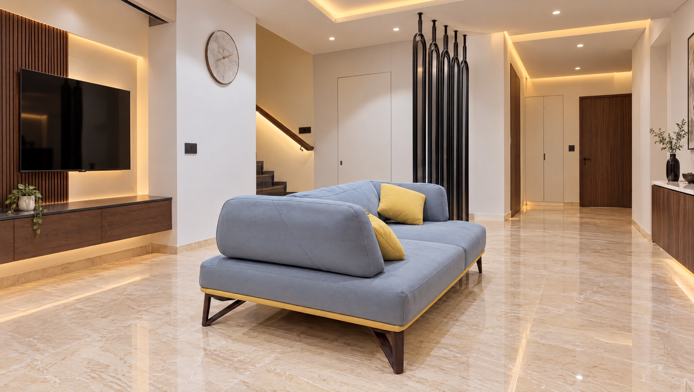 Living room with a low sofa and a black sculpted screen